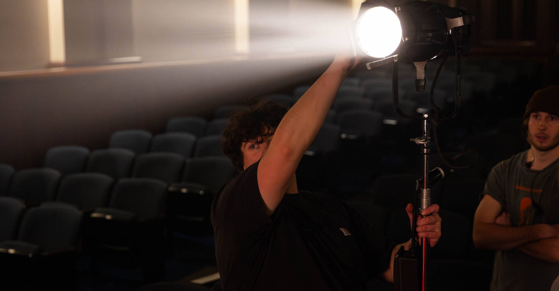 Josh holding camera while filming an event